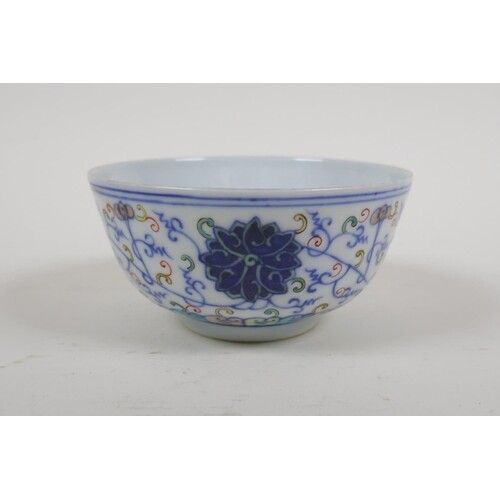 A Chinese polychrome porcelain rice bowl with scrolling lotu...