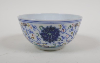 A Chinese polychrome porcelain rice bowl with scrolling lotus...