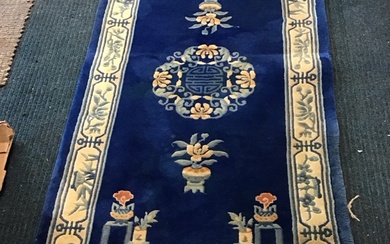 A Chinese wool carpet with central floral Shou medallion on...