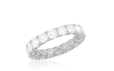 A DIAMOND ETERNITY RING Composed of a continuous row of bri...