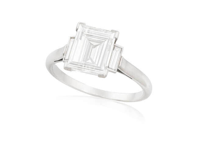 A DIAMOND SINGLE-STONE RING The central rectangular-cut diamond...