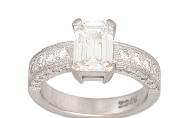 A DIAMOND SOLITAIRE RING, the emerald cut diamond to diamond...