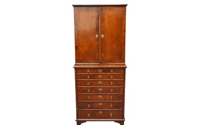A FEATHER BANDED WALNUT CABINET ON CHEST CIRCA 1920-1930