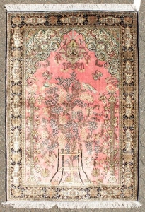 A FINE PERSIAN SILK QUM RUG with a tree pattern and