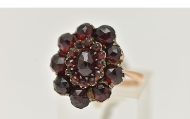 A GARNET CLUSTER RING, the early 20th century cluster set wi...