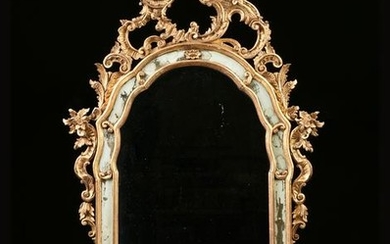 A GEORGE II STYLE CARVED AND PARCEL GILT WOOD MIRROR