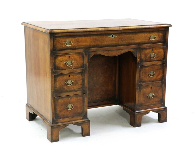 A George II style walnut kneehole desk