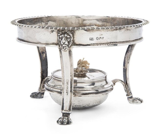 A George III silver burner and stand, London, 1816, William Eaton, the stand designed with three paw feet to lion mask shoulders and gadrooned rim, the burner engraved with crest, stand 10cm high, 15.7cm dia., approx. weight of stand 10.4oz, gross...
