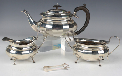 A George V silver three-piece tea set, comprising teapot, milk jug and sugar bowl, each of faceted o