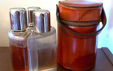 A Leather Cased Trio of Glass Decanters