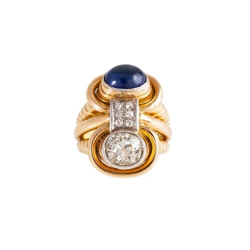 A MID 20TH CENTURY DIAMOND AND SAPPHIRE TWO STONE RING, of r...