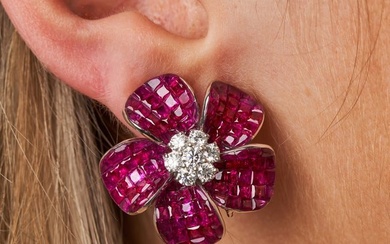 A PAIR OF RUBY AND DIAMOND FLOWER EARRINGS each designed as a flower set with a cluster of round