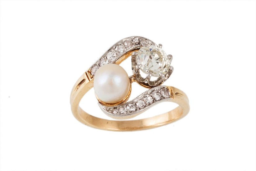 A PEARL AND DIAMOND CROSSOVER RING, the diamond estimated to...