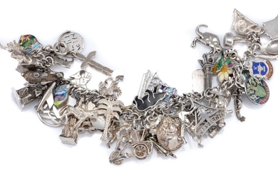 A SILVER CHARM BRACELET set with approx. 55 assorted charms some enamelled, length 18cm, wt. 93.83g.
