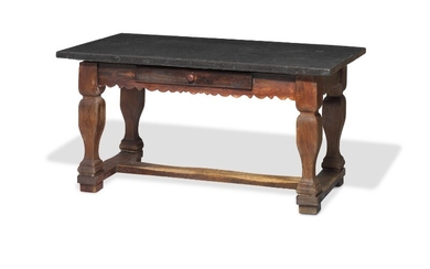 A Swedish table of dark polished oak and pinewood with Komstad stone top adorned with fossils. C. 1800. H. 81 cm. L. 161 cm. W. 83 cm.