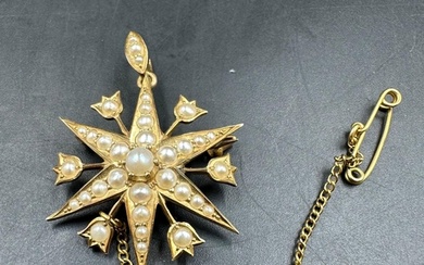 A Victorian star brooch with seed pearl decoration on 15ct y...
