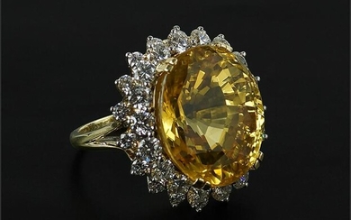 A Yellow Sapphire & Diamond Ring.