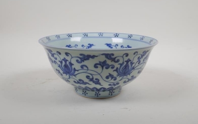 A blue and white porcelain bowl with scrolling lotus...