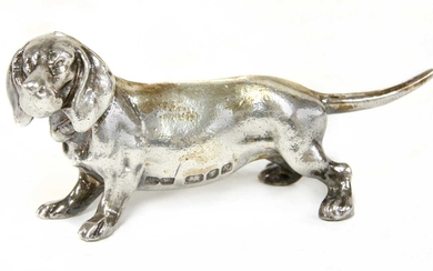 A cast silver figure of a dachshund