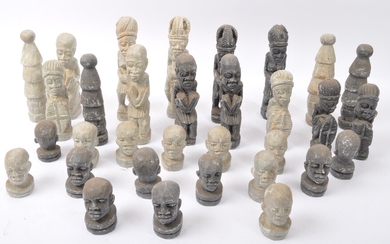 A collection of 20th century carved composite stone tribal figures in a variety of sizes and positions, each wearing traditional dress. Measures approx 17cm tall.