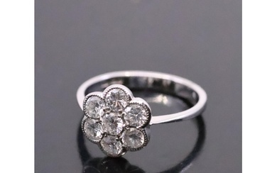 A diamond daisy cluster ring set in 18ct gold, finger size ...