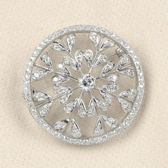 A diamond openwork floral brooch.Principal diamond