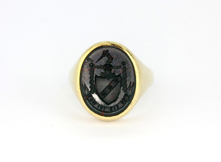 A gentleman's yellow metal (tested 9ct gold) signet ring set with bloodstone, (N).