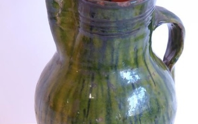 A green-glazed two-handled pottery jug (possibly early English) (24cm)...