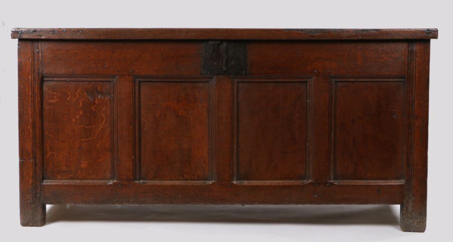 A large oak coffer/chest, circa 1650, the rectangular end-cleated hinged top enclosing storage space