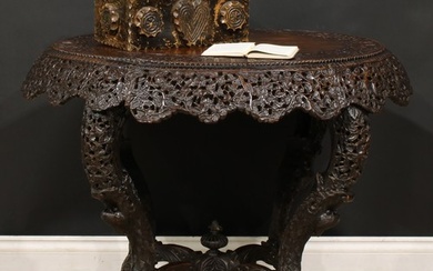 A late 19th century Burmese hardwood centre table, oval top,...