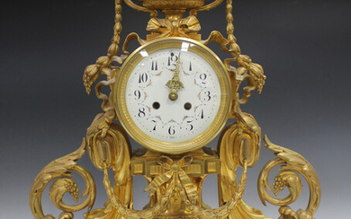 A late 19th century French ormolu cased mantel clock, the circular enamel dial with black Arabic num