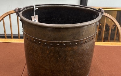 A late Victorian Arts and Crafts hammered copper coal bucket...
