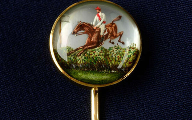 A late Victorian gold, reverse-carved and painted stickpin, depicting 1883 Grand National winner Zoedone, ridden by owner Count Charles Kinsky.
