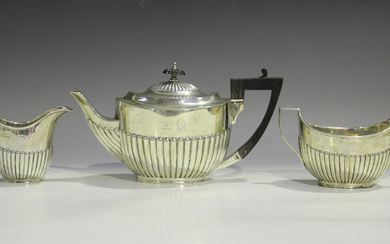 A late Victorian silver and half-reeded three-piece tea set, comprising teapot, two-handled sugar bo