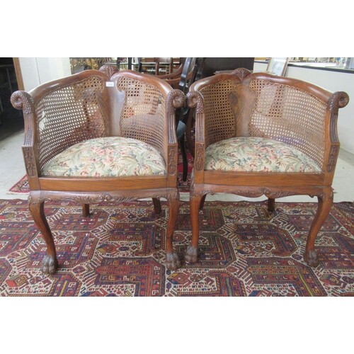 A pair of Art Deco walnut framed bergere chairs, the caned b...