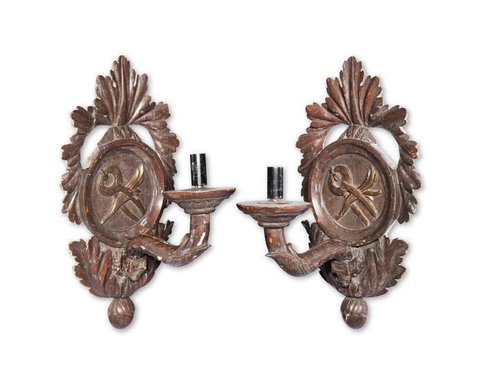 A pair of Continental carved and silvered wood wall appliques