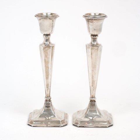 A pair of George V silver candlesticks, Chester, 1913, Clark & Sewell, the tapering squared stems to square feet with canted corners, 26.3cm high (bases filled)