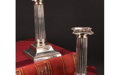 A pair of George V silver fluted Corinthian column candlesti...