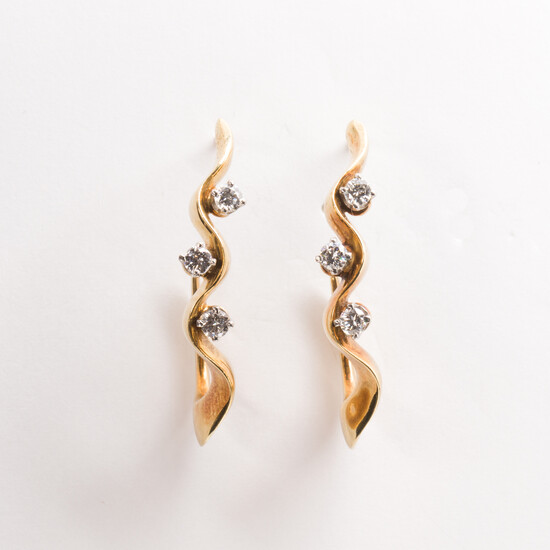 A pair of diamond and eighteen karat gold pendant earrings