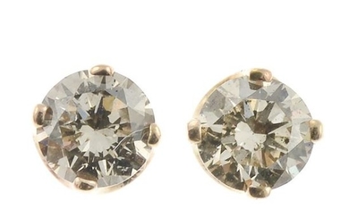 A pair of diamond single-stone stud earrings.Estimated total...
