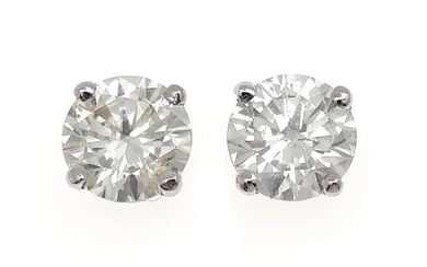 A pair of ear studs each set with a brilliant-cut diamond weighing...
