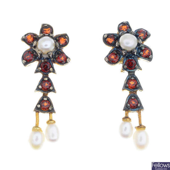 A pair of garnet and seed pearl floral earrings.