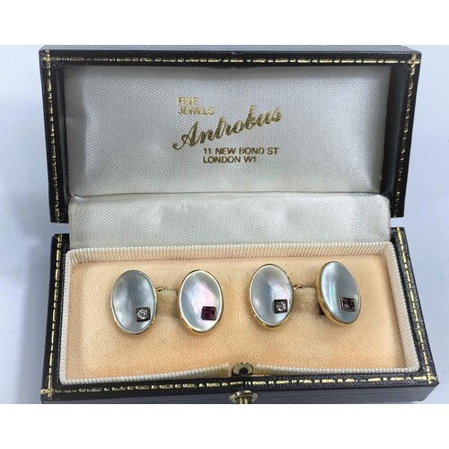 A pair of yellow metal cufflinks with oval mother of pearl i...