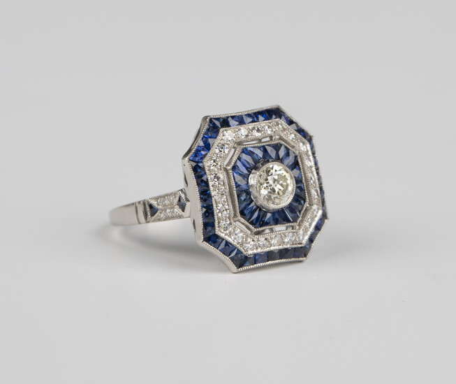 A platinum, diamond and sapphire canted corner square cluster ring, collet set with the principal ci