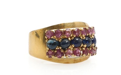 A sapphire and ruby ring set with five cabochon-cut sapphires flanked by...