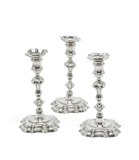 A set of three George II silver candlesticks