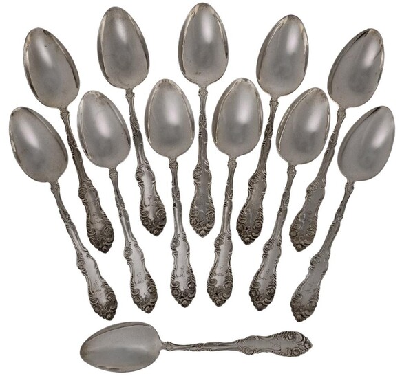A set of twelve Canadian silver table spoons, P.W. Ellis & Co., Ontario, 1872-1928, with floral scroll decoration to stems and terminals, each engraved with initial, total weight approx. 24.4oz (12) (VAT charged on hammer price)