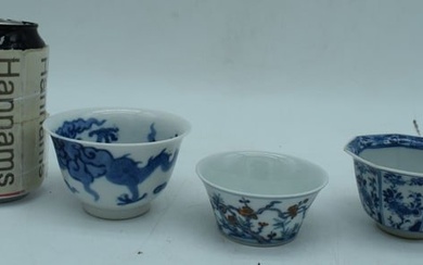 A small Chinese porcelain blue and white dragon bowl with two small bowls 6 x 9 cm. (3)