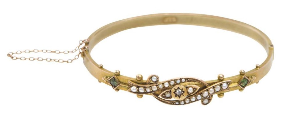 AN ANTIQUE SEED PEARL, PERIDOT AND DIAMOND BANGLE BY DUNKLINGS