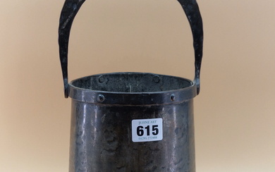 AN ARTS AND CRAFTS HAMMERED SHEET METAL PAIL, THE COPPER BANDED RIM FIXED WITH A HORSE SHOE SHAPED